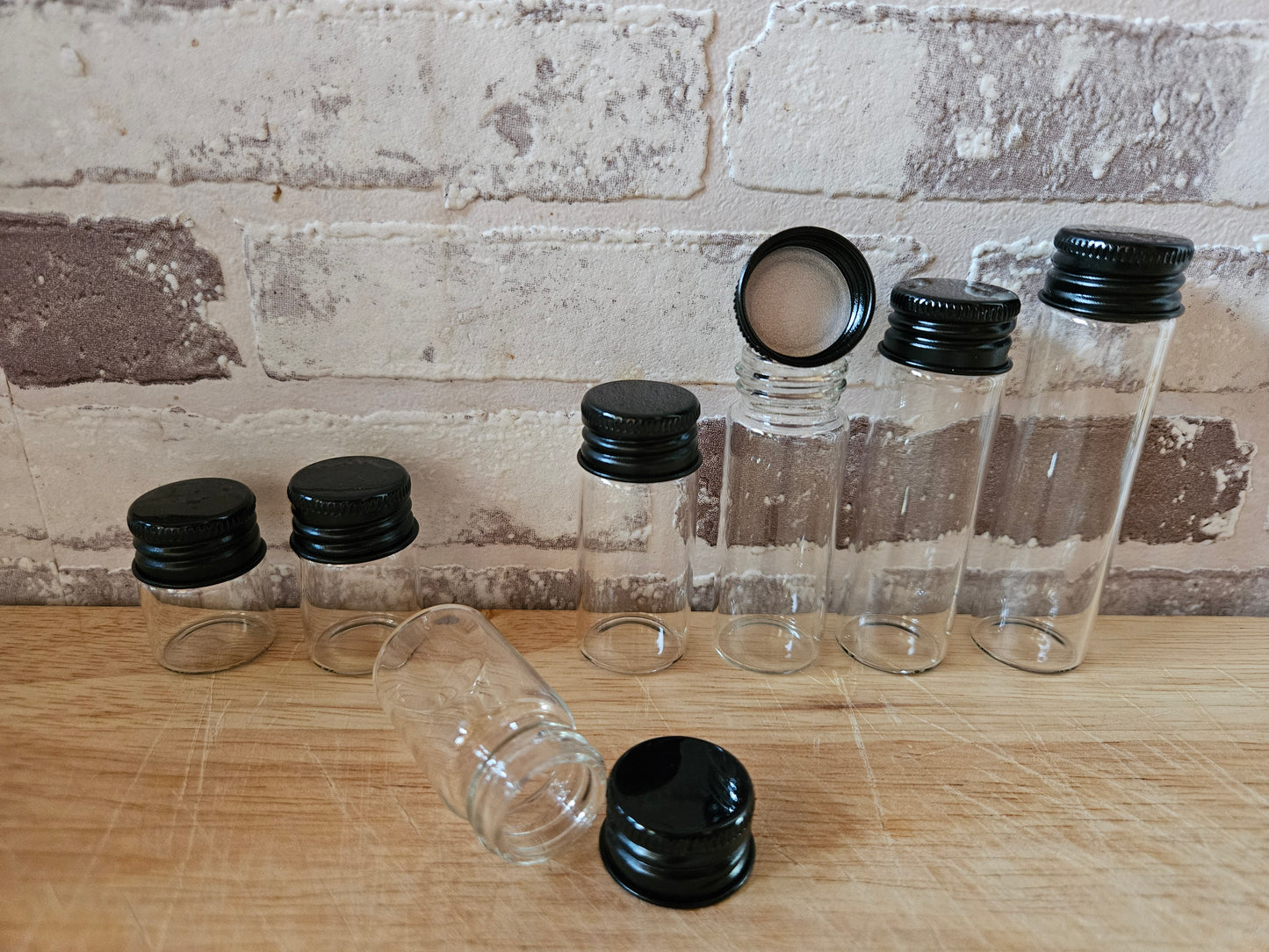 Mini glass bottle with aluminum screw cap in black